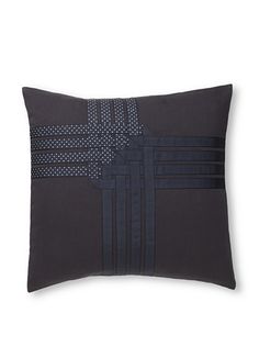 a black and grey pillow on a white background with an embroidered cross in the center