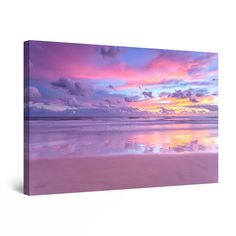 the sky is reflected in the water at sunset on an ocean beach with pink and purple clouds