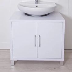 a white bathroom sink sitting on top of a cabinet