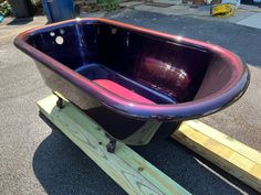 a purple tub sitting on top of a wooden platform