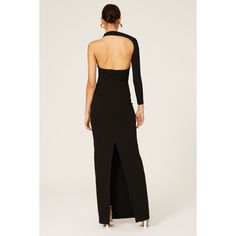 the back of a woman wearing a black dress with an open neck and high slit