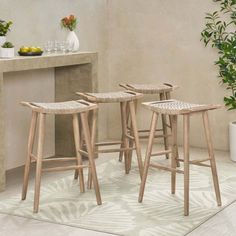 three wooden stools in front of a counter