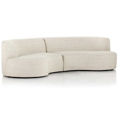 a white couch sitting on top of a white floor