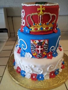 a three tiered cake with a crown on top is decorated in red, white and blue