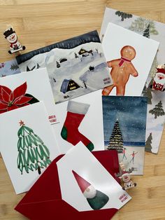 several christmas cards on a wooden table