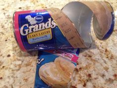 a bag of bread sitting on top of a counter next to a can of grands