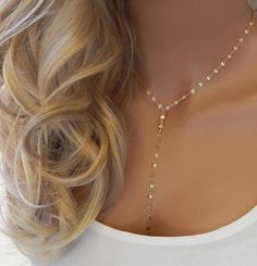 "GOLD LARIAT NECKLACE CHOKER This gold or silver drop necklace features dainty shiny discs that catch the light and is very sparkly. The model in photo #1 is wearing 17\" with the small disc chain. IT'S IN THE DETAILS ✦ 14K Gold Filled or Sterling Silver ✦ Chain Drops of 4\" and 5\" ✦ Large or small discs (See photo #4) ✦ Necklace is shown at 17\" in photo #3 For matching earrings, click here: https://www.etsy.com/listing/590775763 ✦ For Layered Lariat, as shown in photo #5, click here: https:// Luxury Dainty Lariat Necklace For Gift, Adjustable Delicate Body Chain, Adjustable Bohemian Lariat Necklace With Delicate Chain, Silver Lariat Layered Necklace, Bohemian Lariat Necklace With Clavicle Chain For Parties, Silver Lariat Body Chain As Gift, Adjustable Lariat Layered Necklace With Chain Detail, Adjustable Lariat Drop Necklace With Clavicle Chain, Bohemian Lariat Necklace With Delicate Chain As Gift