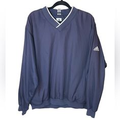 Adidas Navy Blue With White Detail Pullover Windbreaker With Pockets Size Large Style # Rn 88387 Fabric Content: 100% Polyester Machine Wash Cold Excellent Condition, No Flaws From Shoulder To Bottom Hem 27” From Armpit To Armpit 25.5” Measurements Are Approximate And Laying Flat If Ordered Before Noon Cst Shipped Same Day! Tags: Casual, Comfy, Lightweight, Lulu, Asos, Athletic, Athletica, Active, Cropped, Crop, Pullover, Long Sleeves, Is, Rare, Htt, Hard To Find, New, Bnwt, Workout, Work Out, A Casual Long Sleeve Windbreaker For Layering, Blue Long Sleeve Windbreaker With Ribbed Cuffs, Casual Navy Outerwear With V-neck, Navy Long Sleeve Sporty Windbreaker, Casual Navy V-neck Outerwear, Adidas Blue Sporty Windbreaker, Navy Long Sleeve Windbreaker, Adidas Navy Blue, Retro Blue Long Sleeve Windbreaker