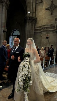 the bride and groom are walking down the aisle