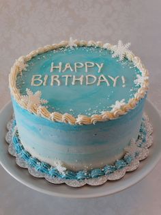 a blue and white birthday cake with the words happy birthday written on it in frosting