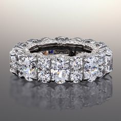 a wedding ring with rows of diamonds on it