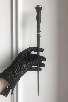 a person's hand holding onto a black handle on a door