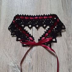 This handmade crochet black lace choker necklace is tied with a claret colour satin ribbon. A simple yet elegant accessory that will work well with a lot of looks. The choker is similar to the Victorian lace collar. Teenagers, who prefer clothes in the Gothic style, also like to wear them to emphasize their individuality. The choker can be used as an additional accent for creating costumes for Cosplay. Made from 100% high-quality mercerized cotton. Choker length 35 cm / 13,8 inches, width - 4,6 Black Ribbon Choker For Party, Black Ribbon Choker As A Gift, Black Ribbon Choker Gift, Black Ribbon Choker For Gifts, Handmade Black Wedding Choker, Handmade Black Choker For Wedding, Black Lace Choker Necklace, Choker Necklace Handmade, Crochet Choker