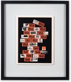 an orange and black poster with numbers on it's side in a white frame