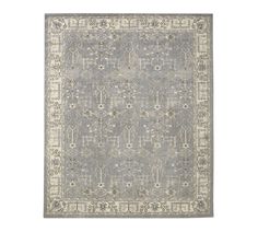 a gray and white rug with an intricate design on the bottom, in front of a white background