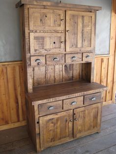 an old wooden cabinet sitting on top of a hard wood floor