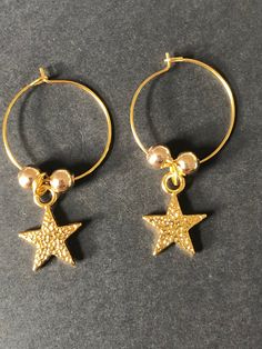 Handmade gold star hoop earrings  ⭐️ Gold plated hoop earrings with gold plated star charms & beads ⭐️ Lightweight & easy to wear Purchasing as a gift? Upgrade to a gift box: https://etsy.me/3gDqVD1 Gold Star-shaped Jewelry With Dangling Charms, Gold Star-shaped Hoop Earrings With Ear Wire, Gold Star Charm Hoop Earrings, Celestial Small Hoop Earrings With Star Charm, Gold Hoop Earrings With Star Charm For Gift, Gold Hoop Earrings With Star Charm As A Gift, Celestial Gold Dangle Hoop Earrings, Gold Hoop Earrings With Charms As Gift, Gold Star-shaped Single Hoop Earring