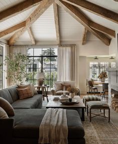 a living room filled with furniture and a fire place in the middle of a room