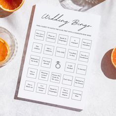 the wedding ring game is next to some oranges and wine glasses on a table