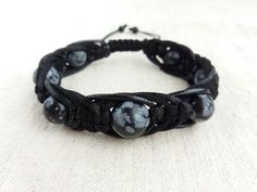 "The protection bracelet made of beads Snowflake obsidian (12mm, 10mm) , braided with three cords of different texture (satin cord, waxed cord and leather cord). Obsidian is lustrous volcanic glass; molten lava that cooled so quickly it had no time to crystallize. Obsidian has no boundaries or limitations, as a result works extremely fast and with great power. Obsidian is a strongly protective stone, forming a shield against negativity, provides a grounding cord from the base chakra to the cente Men Leather Bracelet, Base Chakra, Molten Lava, Obsidian Bracelet, Beaded Snowflakes, Bracelet Men, Snowflake Obsidian, Braided Leather Bracelet, Protection Bracelet