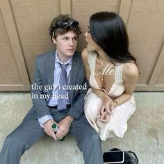 a man and woman sitting on the ground next to each other with words written in front of them