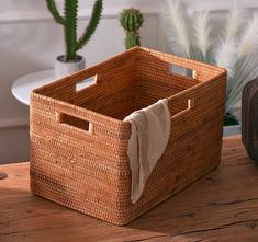 an empty basket sitting on top of a wooden table