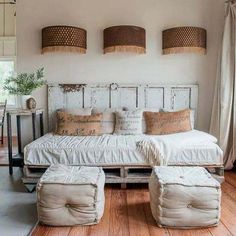 a white day bed sitting on top of a wooden floor