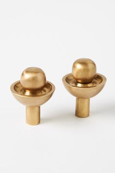 two brass knobs on white background