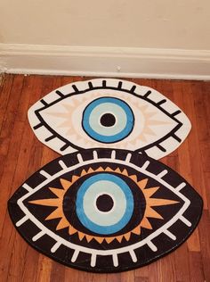 two rugs with an eye design on them