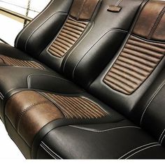 two black and brown leather seats with stitching on them