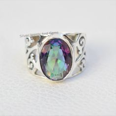 Gemstone-Mystic Topaz Shape-Oval Stone Size- 10x14 MM Metal-925 Sterling Silver This One of a kind ring is adorned with beautiful Multicolour Mystic Topaz Gemstone set in sterling silver. About gemstones-Mystic Topaz is one of a kind stone which showcase multicolour. It sparkle and amazing colors are enough reasons for anyone to be dazzled by them.This beautiful gemstone not only possess physical healing properties but also magical healing properties.Wearer of the stone can be protected from neg Iridescent Oval Spiritual Rings, Spiritual Iridescent Oval Rings, Iridescent Oval Sterling Silver Rings, Mystical Oval Crystal Ring For Anniversary, Mystical Oval Gemstone Rings, Iridescent Spiritual Rings For Anniversary, Mystic Topaz Ring, Mystic Topaz, Silver Rings Handmade