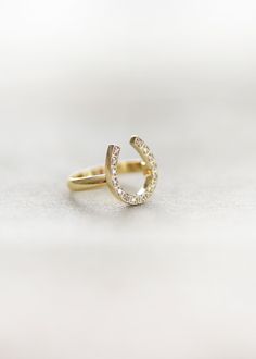 The horseshoe is a powerful symbol of good luck and protection. An elegant and subtle statement ring with a hint of pave diamonds. This ring is available in Sterling Silver, 14 Karat Gold, 14 Karat Rose Gold and 14 Karat White. 1/3 of an inch tall This ring takes 3-4 weeks to make and ship. If you are unsure of your size we can help you out with that! Just select the "Not Sure of my Size" option and we will send a ring sizer to you and confirm your ideal fit. *Kristin Hayes Jewelry is happy to w Horseshoe Jewelry, Horseshoe Ring, Country Rings, Looks Country, Horse Jewelry, Ring Sizer, Pave Diamonds, Statement Ring, Good Luck