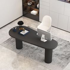 a black table with a laptop on it and a white chair in the back ground