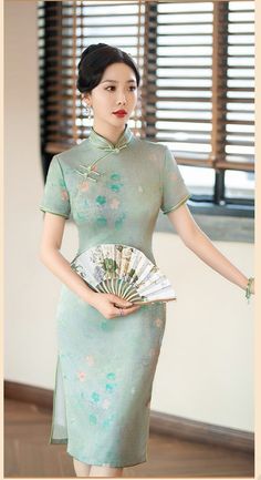 Embrace the exquisite elegance of this green Cheongsam dress, adorned with a delicate floral print and a traditional mandarin collar. The short sleeve design and knee-length cut are complemented by two subtle side slits, creating a timeless and sophisticated silhouette perfect for any special occasion. Size Guide: Please refer to the size guide picture before placing the order. Please leave your Height, Weight , Bust, Waist and Hip measurements in the Personalisation box so we could double check Green Cheongsam, Qipao Cheongsam, Qipao Dress, Chinese Design, Cheongsam Dress, Chinese Dress, Delicate Flower, Cheongsam, Mandarin Collar