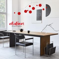 a dining room table with chairs and an advertisement on the wall above it that says education