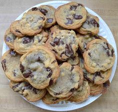 a plate full of chocolate chip cookies on a table