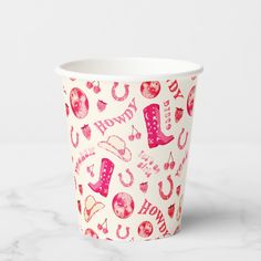 a paper cup with pink and red designs on it