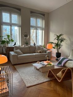 a living room filled with furniture and lots of windows