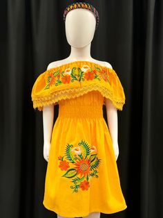 This beautiful embroidered Mexican floral dress with sunflowers and tulips is perfect for a special ocassion or fiesta. It has elastic on the waist. Sleeves can be worn up or down. Embroidered Flower Dress For Summer, Traditional Floral Embroidered Dress For Spring, Traditional Embroidered Floral Dress For Spring, Traditional Spring Floral Embroidered Dress, Casual Summer Dress With Floral Applique, Embroidered Dresses For Spring Fiesta, Spring Fiesta Dress With Embroidered Hem, Yellow Embroidered Fitted Dress, Spring Fiesta Dress With Multicolor Embroidery