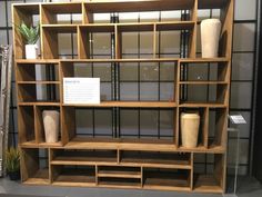 a wooden shelf filled with lots of different types of vases and other decorative items