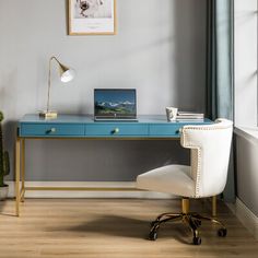 a desk with a laptop on it next to a potted plant and a window