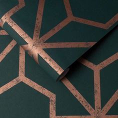 a green wallpaper with copper foiled geometric designs on it's side and the top half