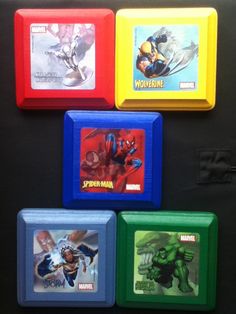 four different colored boxes with pictures of superheros on them