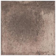 a brown area rug that is very soft and shaggy looking with some stains on it