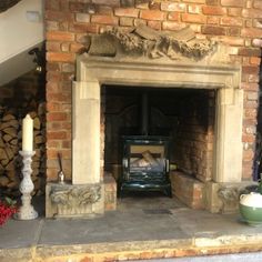 a fireplace with a fire in it surrounded by flowers