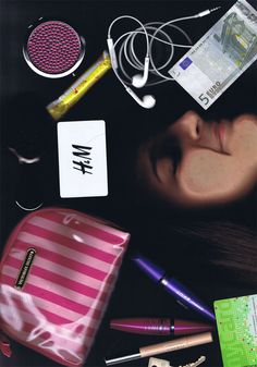 a woman's face surrounded by various personal items