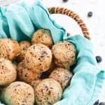 a basket filled with blueberry muffins sitting on top of a white table