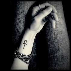 a woman's wrist with an anchor tattoo on it