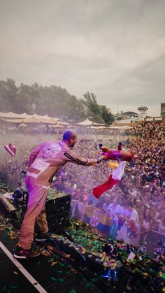 a man on stage with confetti in his hand