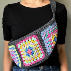 a woman is wearing a crocheted bag